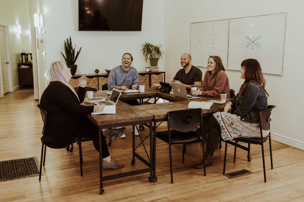 The Beyond Healing team gathered around a table for a meeting